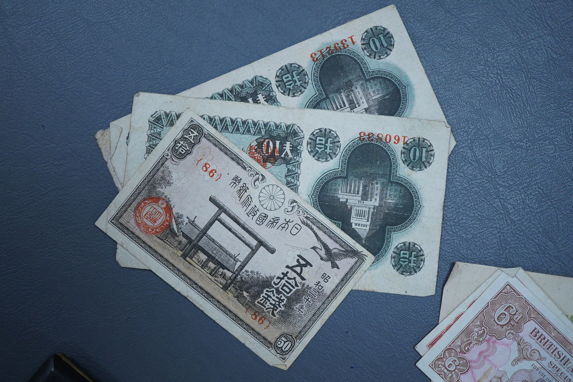 A Japanese photograph album, late 1940's to include banknotes and a telegram, together with a cigarette case